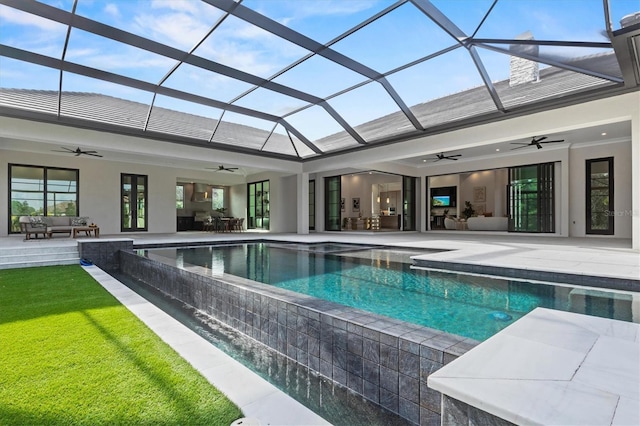 view of swimming pool featuring a lanai, outdoor lounge area, a patio, and ceiling fan