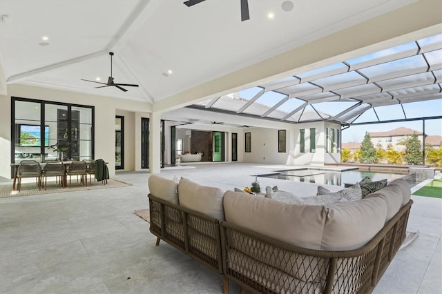 view of patio with ceiling fan, outdoor lounge area, and glass enclosure