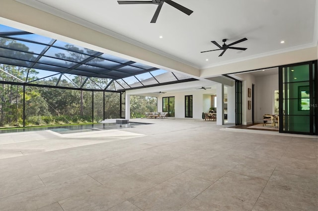 view of patio with ceiling fan and glass enclosure