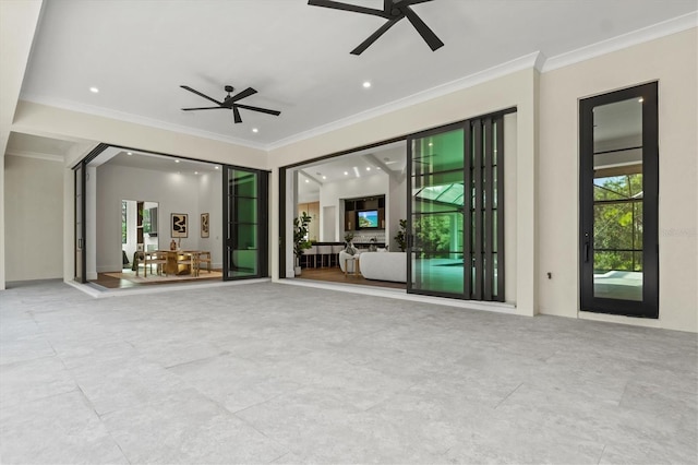 unfurnished living room with crown molding and ceiling fan