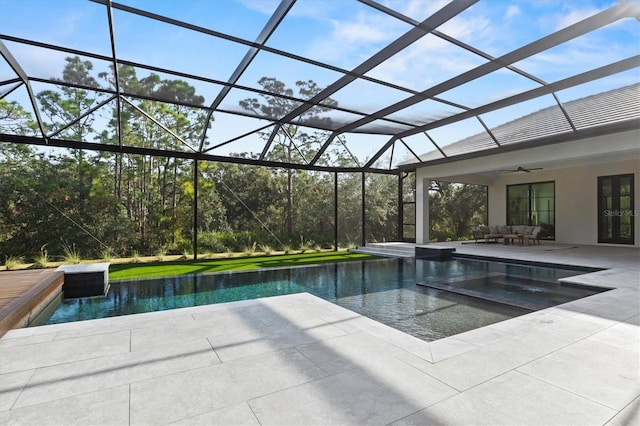 view of swimming pool featuring an outdoor hangout area, a patio area, ceiling fan, and glass enclosure