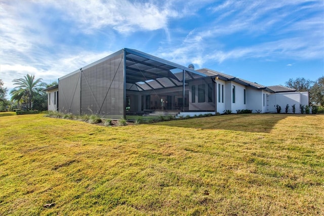 back of property featuring a lanai and a yard