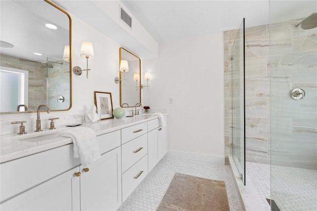 bathroom with tile patterned flooring, vanity, and a shower with door