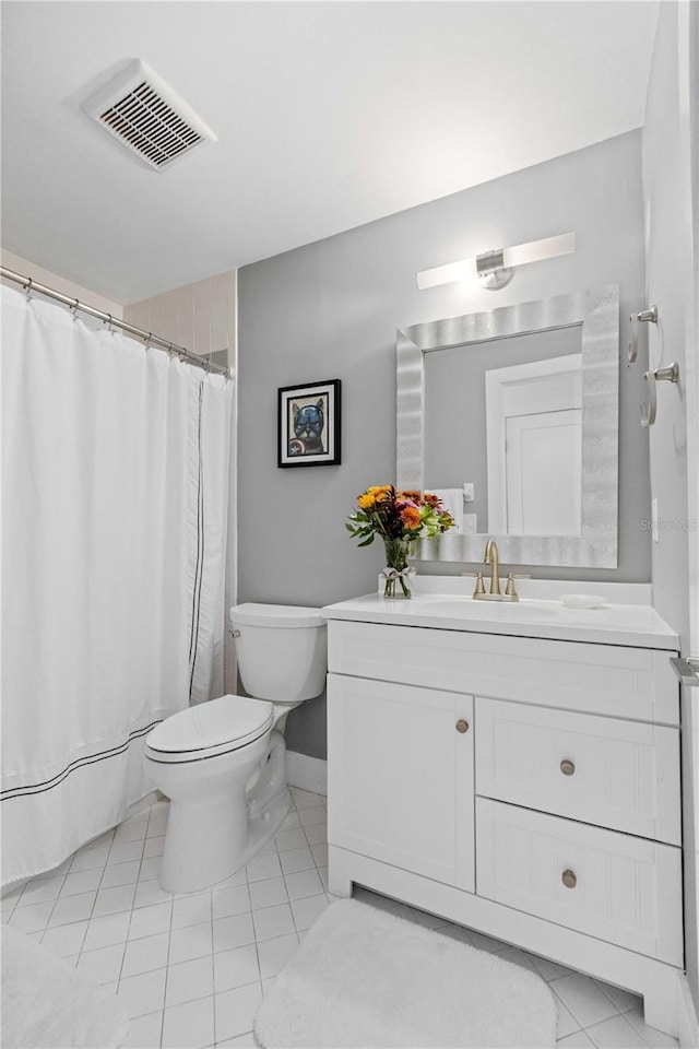 bathroom with walk in shower, vanity, toilet, and tile patterned flooring