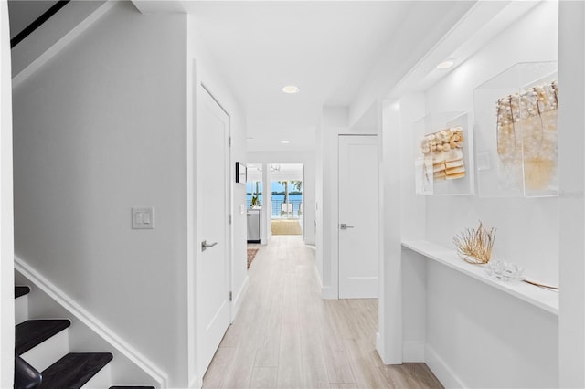 corridor with light hardwood / wood-style floors