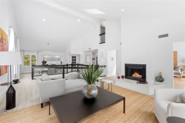 living room with high vaulted ceiling, a notable chandelier, beam ceiling, and light hardwood / wood-style floors