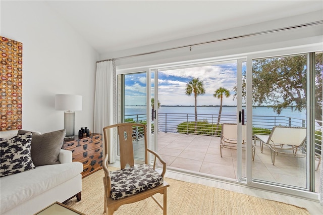 interior space with a water view and lofted ceiling