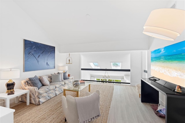 living room featuring lofted ceiling with skylight and light hardwood / wood-style flooring