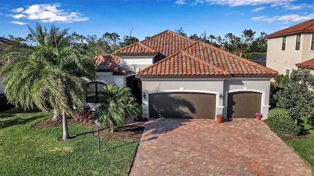 mediterranean / spanish home with a garage and a front yard