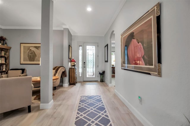 entryway featuring light hardwood / wood-style flooring and ornamental molding