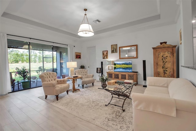 living room featuring crown molding and a tray ceiling