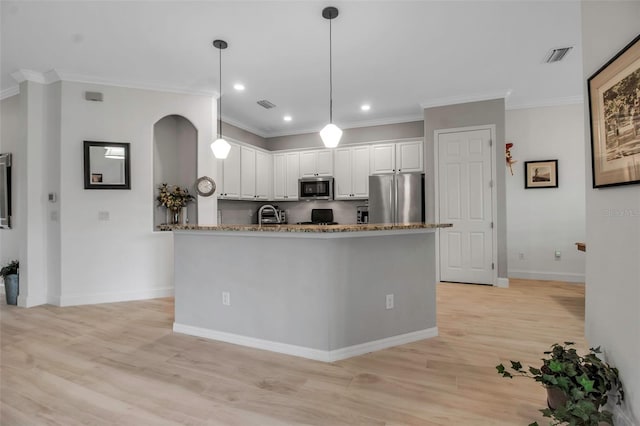 kitchen with stone counters, pendant lighting, white cabinetry, light hardwood / wood-style floors, and stainless steel appliances