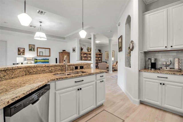 kitchen with sink, dishwasher, hanging light fixtures, decorative columns, and white cabinets