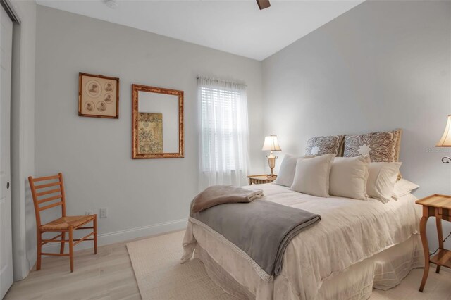 bedroom with ceiling fan and light hardwood / wood-style flooring