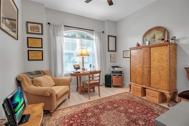 living area featuring light hardwood / wood-style flooring and ceiling fan