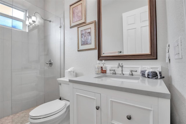 bathroom featuring vanity, an enclosed shower, and toilet