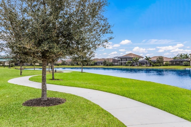 view of home's community featuring a water view and a lawn