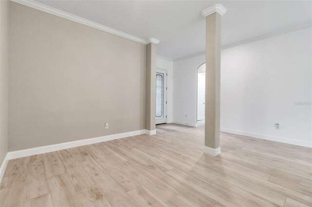 13303 Swiftwater Way, Lakewood Ranch, FL 34211 - empty room with ornamental molding, light wood-type flooring, baseboards, arched walkways, and decorative columns