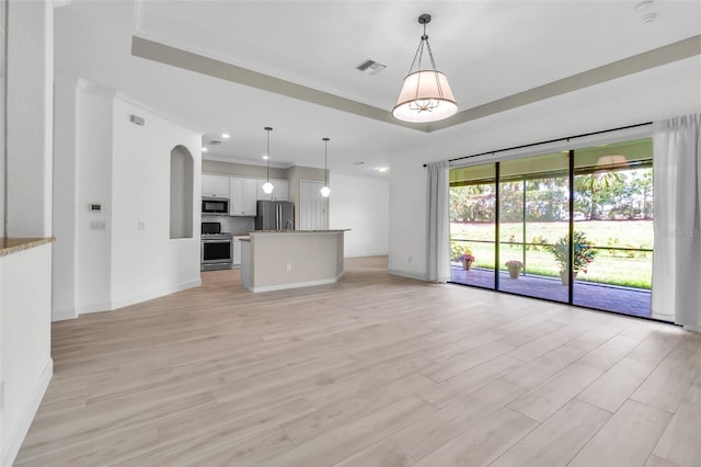 13303 Swiftwater Way, Lakewood Ranch, FL 34211 - unfurnished living room with baseboards, light wood-style floors, a tray ceiling, recessed lighting, and ornamental molding