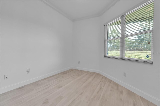 13303 Swiftwater Way, Lakewood Ranch, FL 34211 - empty room with light wood-style flooring, ornamental molding, and baseboards
