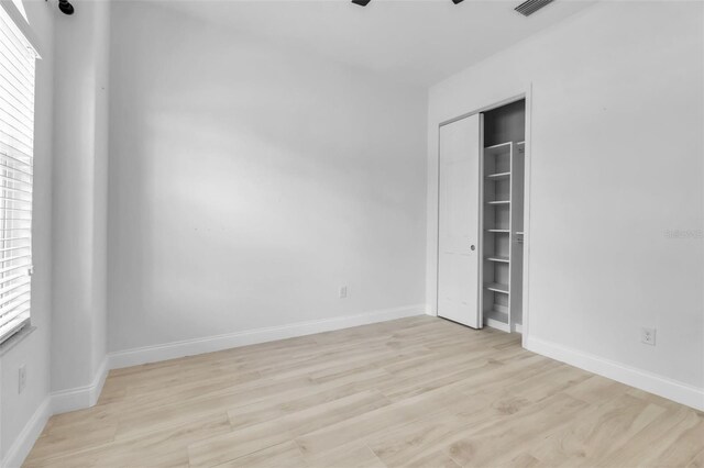 13303 Swiftwater Way, Lakewood Ranch, FL 34211 - unfurnished bedroom featuring light wood-style flooring, baseboards, a ceiling fan, and a closet