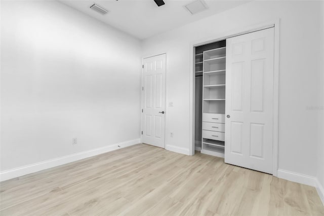 13303 Swiftwater Way, Lakewood Ranch, FL 34211 - unfurnished bedroom with light wood-style flooring, baseboards, a ceiling fan, and a closet