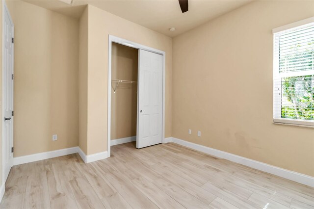 13303 Swiftwater Way, Lakewood Ranch, FL 34211 - unfurnished bedroom with light wood-type flooring, multiple windows, a closet, and baseboards