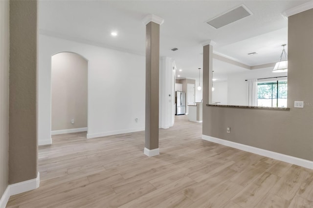 13303 Swiftwater Way, Lakewood Ranch, FL 34211 - empty room with light wood-type flooring, baseboards, and arched walkways