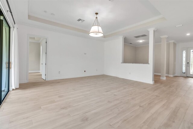 13303 Swiftwater Way, Lakewood Ranch, FL 34211 - unfurnished room with ornate columns, a raised ceiling, crown molding, and light wood-style floors