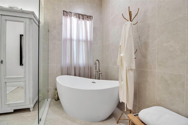 13303 Swiftwater Way, Lakewood Ranch, FL 34211 - full bathroom featuring tile walls and a freestanding bath