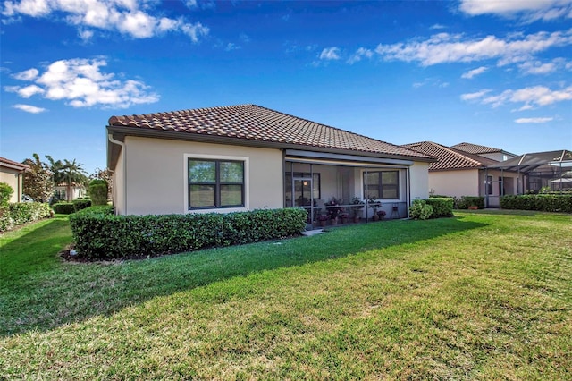 13303 Swiftwater Way, Lakewood Ranch, FL 34211 - back of property with stucco siding, a yard, and a tile roof