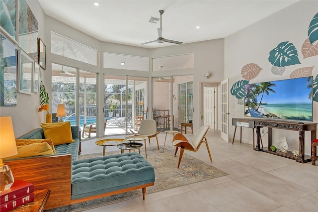 interior space with tile patterned flooring, a high ceiling, and ceiling fan