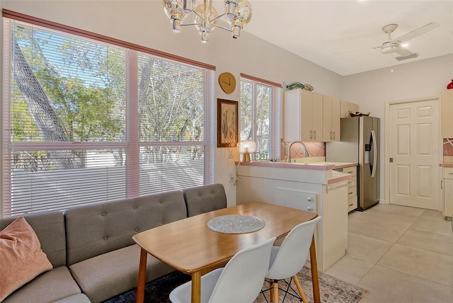 dining space featuring ceiling fan and light tile patterned floors