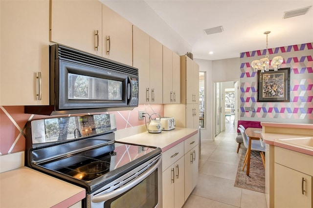 kitchen featuring electric stove, pendant lighting, backsplash, light tile patterned flooring, and cream cabinetry