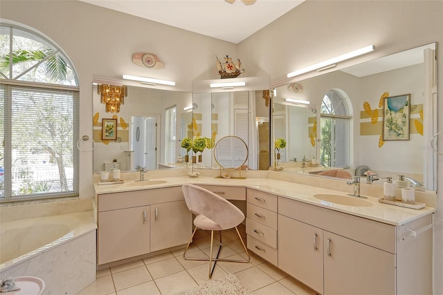 bathroom featuring tile patterned flooring, vanity, and a washtub