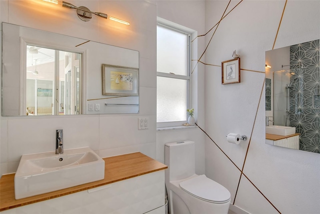 bathroom featuring sink, a shower, and toilet