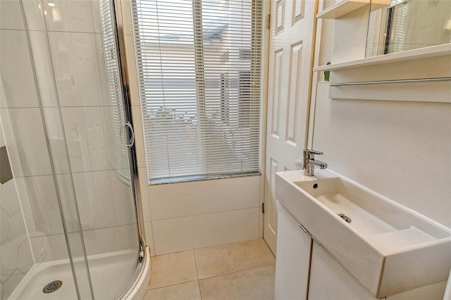 bathroom with a shower with shower door and tile patterned floors