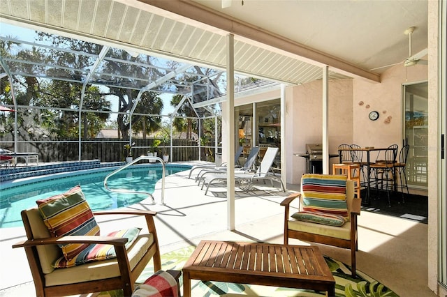 view of swimming pool with a lanai, ceiling fan, and a patio area