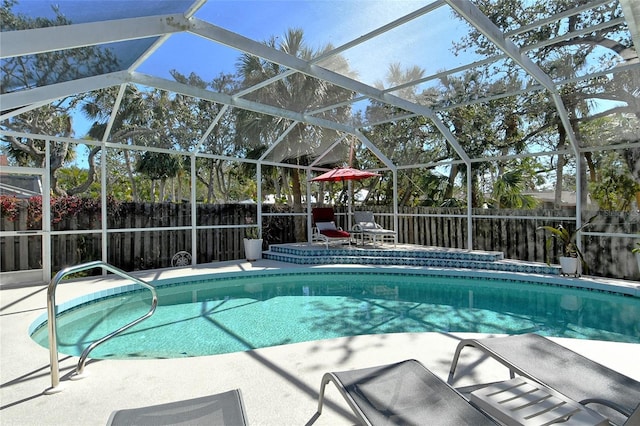 view of swimming pool featuring a lanai