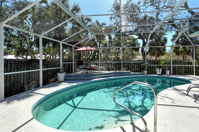 view of swimming pool with a lanai and a patio