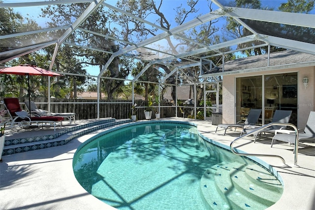 view of pool with a lanai and a patio