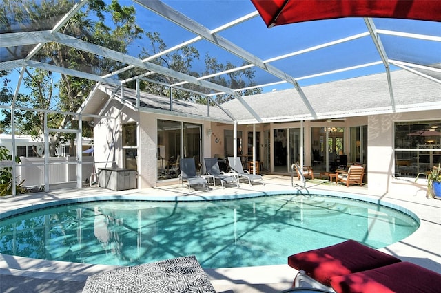 view of swimming pool with a lanai and a patio