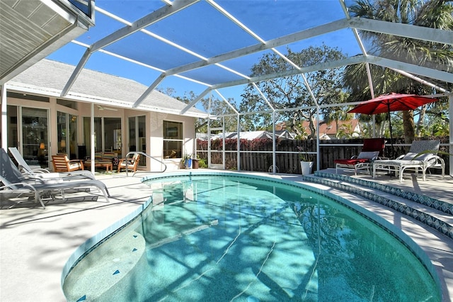 view of swimming pool with a patio and glass enclosure