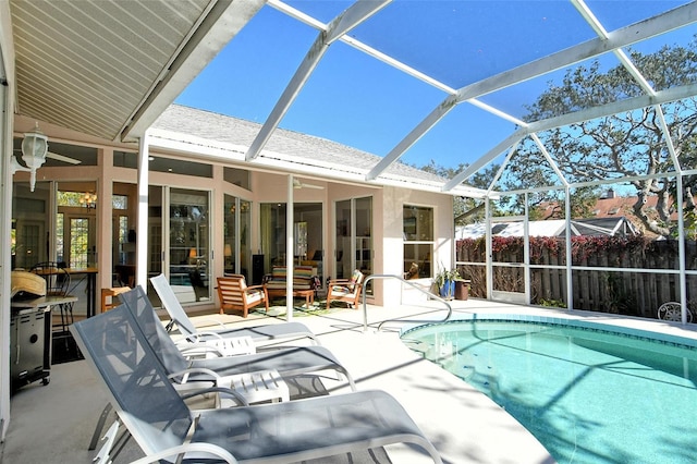 view of swimming pool with glass enclosure and a patio area