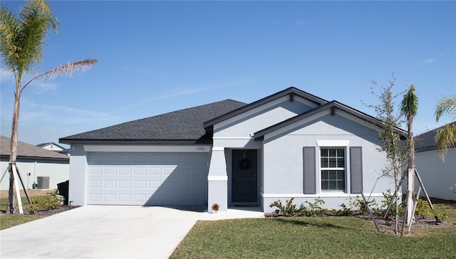 ranch-style home with a garage, a front yard, driveway, and stucco siding