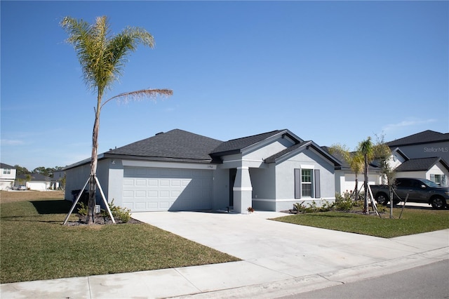 view of front of home with concrete driveway, a front lawn, an attached garage, and stucco siding