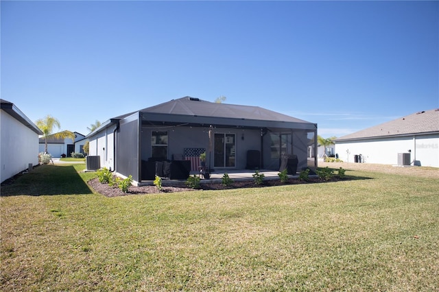 rear view of house with a lanai, a lawn, and central AC unit