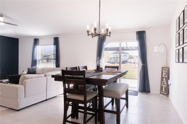 dining room with light tile patterned floors and an inviting chandelier