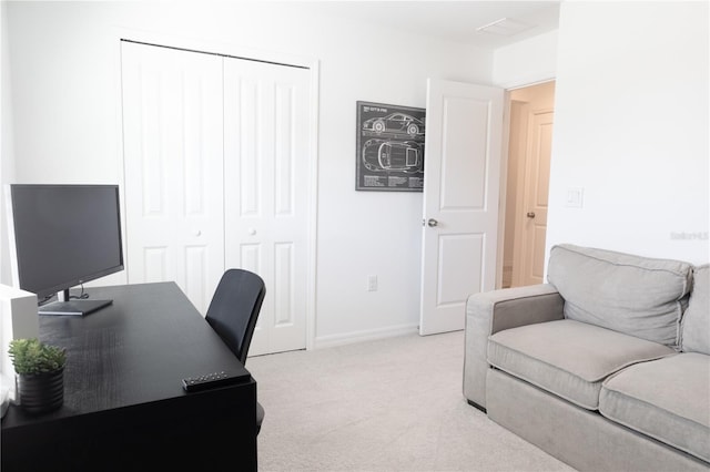 office area featuring baseboards and light colored carpet