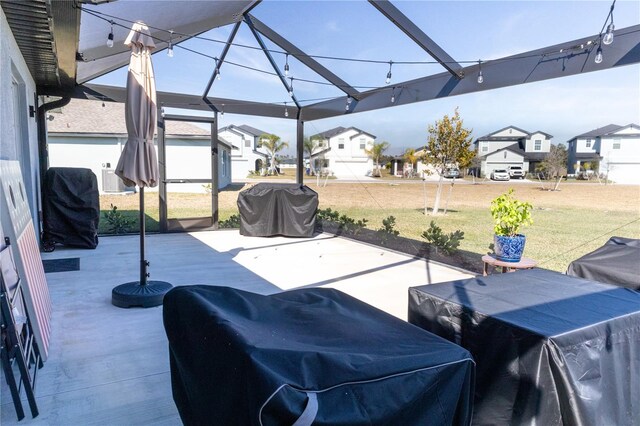 view of patio with a residential view and a grill